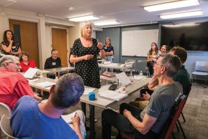 Gwen Nolan talks with participants in the Parkinson Speech program in an SHP classroom