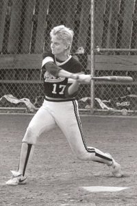 Kris Schmidt swings a bat in a black and white photo