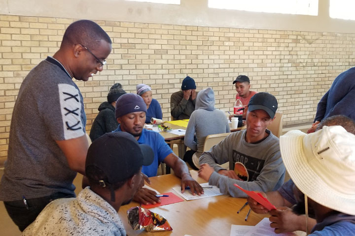 Professor Wilson Majee works with community members in South Africa